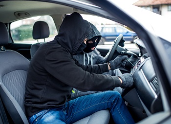 Two car thieves attempting to steal a vehicle